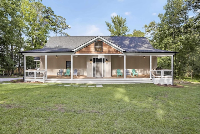 1005 Dennis St, Eatonton, GA 31024 - rear view of house featuring covered porch, a yard, and roof with shingles