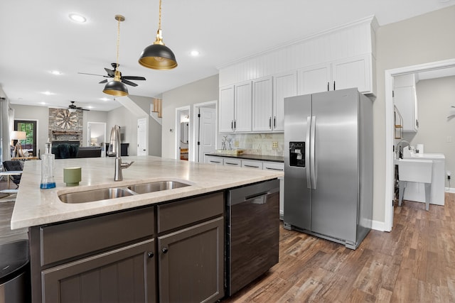 1005 Dennis St, Eatonton, GA 31024 - kitchen featuring appliances with stainless steel finishes, ceiling fan, dark wood-style floors, open floor plan, and tasteful backsplash