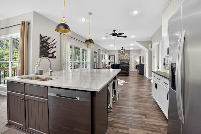 1005 Dennis St, Eatonton, GA 31024 - kitchen with appliances with stainless steel finishes, ceiling fan, open floor plan, a kitchen island with sink, and recessed lighting