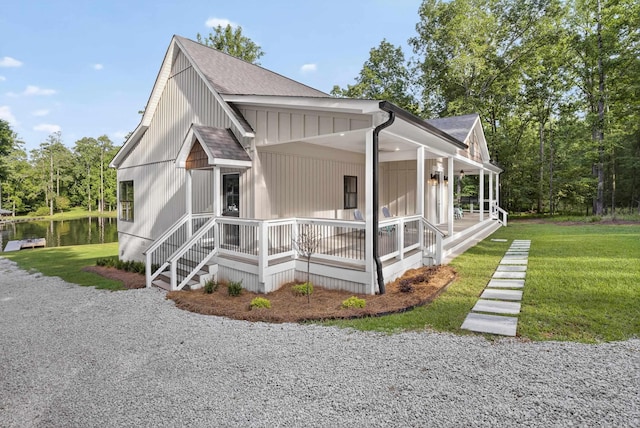 1005 Dennis St, Eatonton, GA 31024 - view of property exterior featuring covered porch, a yard, and a shingled roof