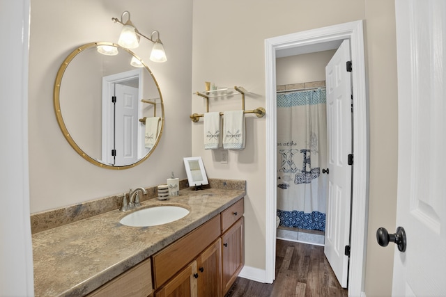 1005 Dennis St, Eatonton, GA 31024 - full bath with vanity, wood finished floors, and curtained shower