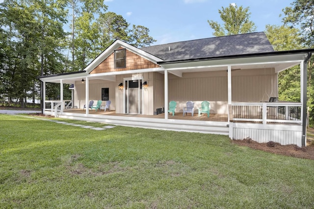 1005 Dennis St, Eatonton, GA 31024 - view of front facade with covered porch, a front lawn, and roof with shingles
