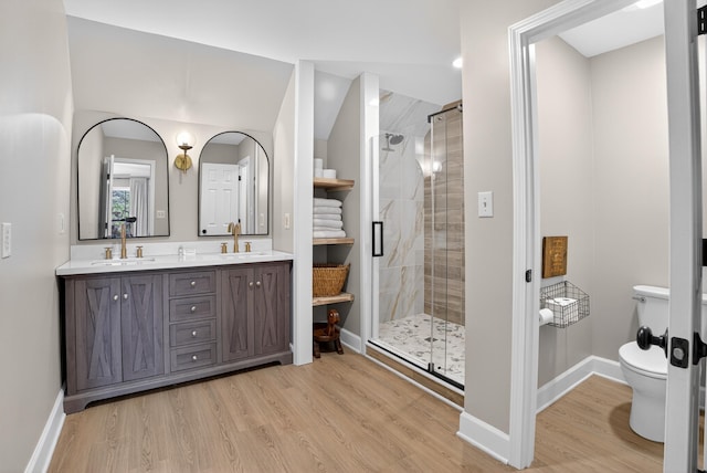 1005 Dennis St, Eatonton, GA 31024 - bathroom featuring double vanity, wood finished floors, and a stall shower
