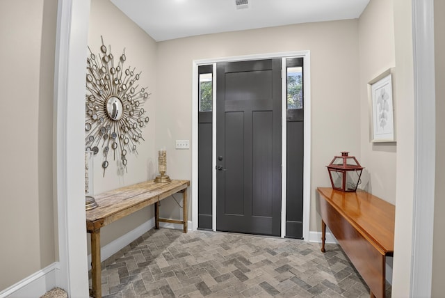 1005 Dennis St, Eatonton, GA 31024 - entrance foyer with baseboards and brick patterned flooring