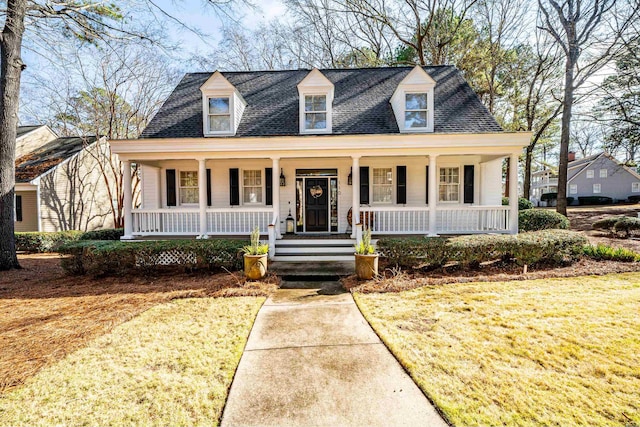 view of front of house with a front yard and covered porch