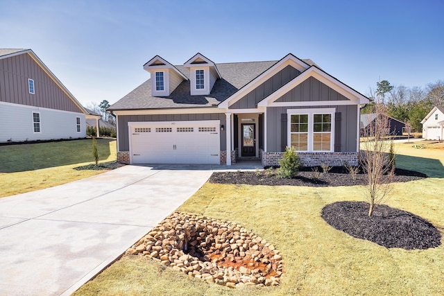 craftsman house featuring board and batten siding, brick siding, driveway, and a front lawn