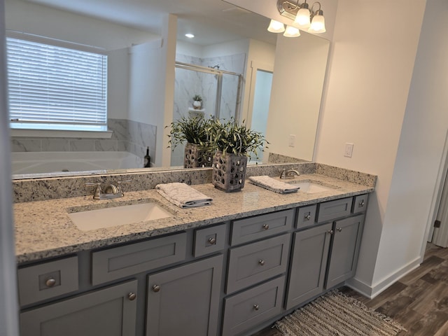 bathroom with independent shower and bath, vanity, and wood-type flooring