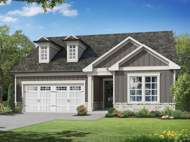 view of front of house with a garage and a front lawn