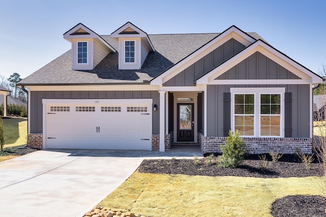 craftsman-style house with driveway, brick siding, board and batten siding, and an attached garage