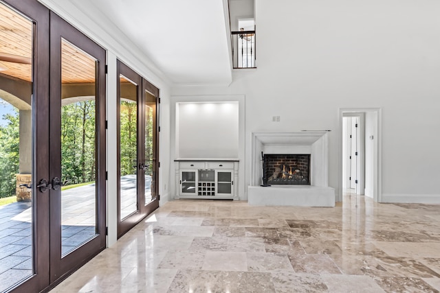 unfurnished living room featuring french doors