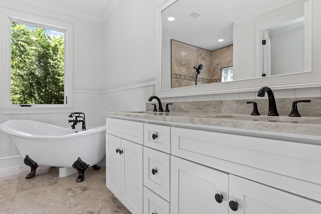 bathroom featuring ornamental molding, vanity, a bathtub, and a wealth of natural light