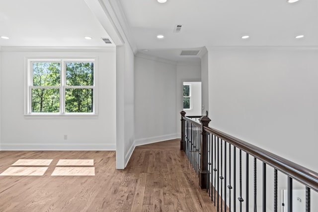 corridor featuring hardwood / wood-style flooring and ornamental molding