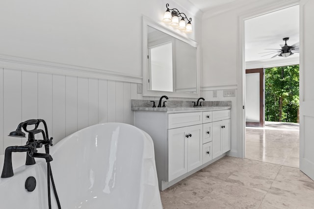 bathroom with vanity, ceiling fan, and a bathtub