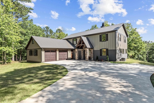 view of front facade featuring a garage, a front yard, and central AC unit