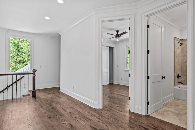 unfurnished room with hardwood / wood-style flooring, crown molding, and a healthy amount of sunlight