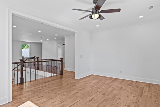 unfurnished room featuring crown molding, ceiling fan, and light wood-type flooring