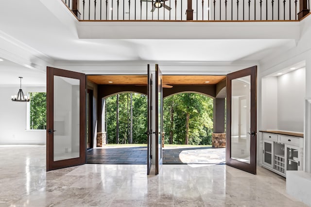 doorway to outside with an inviting chandelier and french doors