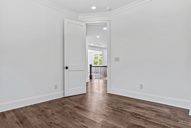 empty room featuring ornamental molding and dark hardwood / wood-style floors