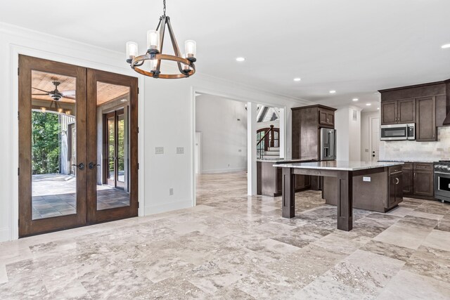 kitchen with a kitchen island, pendant lighting, a kitchen breakfast bar, premium appliances, and dark brown cabinetry