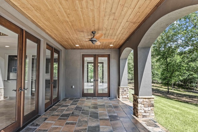 view of exterior entry with french doors and ceiling fan