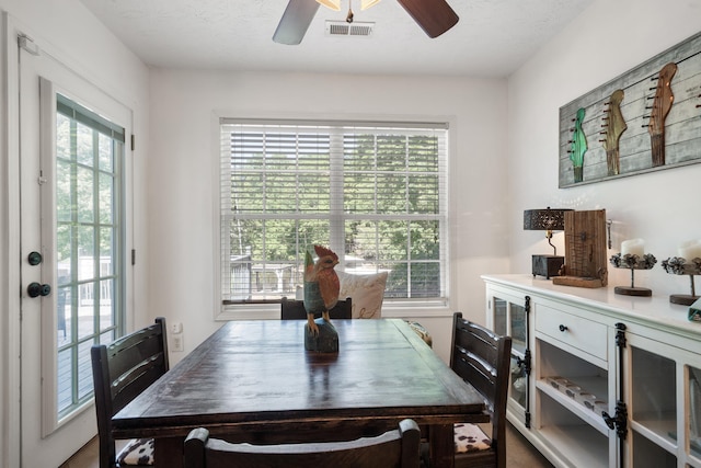 dining room featuring ceiling fan and a textured ceiling