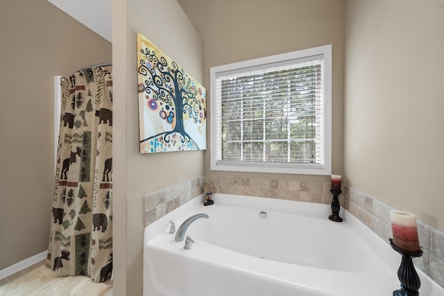 bathroom featuring shower with separate bathtub