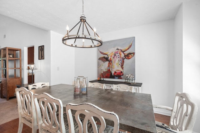 dining room featuring lofted ceiling, hardwood / wood-style floors, and a chandelier