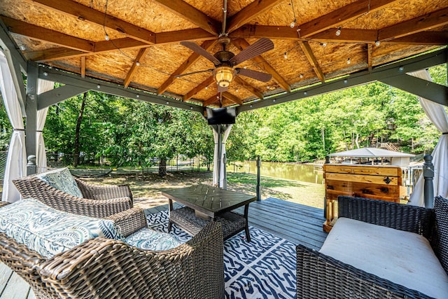 view of patio featuring a gazebo, a water view, and ceiling fan