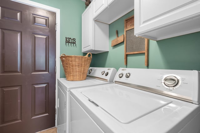 laundry room featuring cabinets and washer and dryer