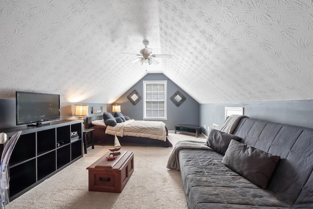 carpeted bedroom with ceiling fan, lofted ceiling, and a textured ceiling