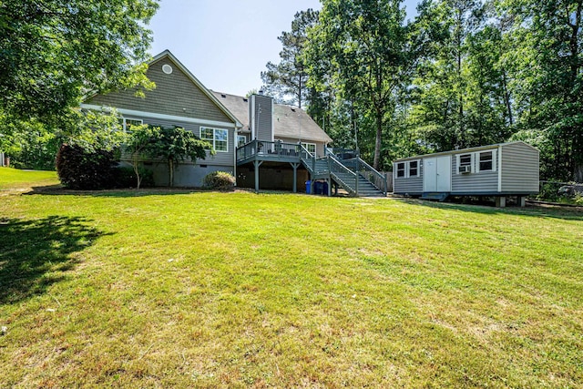 view of yard with a wooden deck and an outbuilding