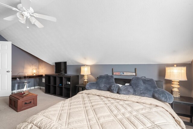 carpeted bedroom with lofted ceiling, a textured ceiling, and ceiling fan