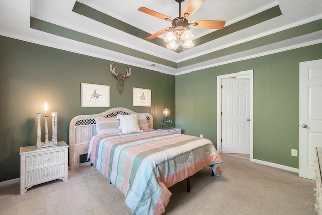 bedroom featuring a tray ceiling, ornamental molding, light colored carpet, and ceiling fan