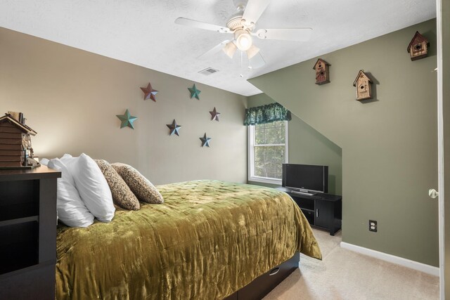 carpeted bedroom with a textured ceiling and ceiling fan