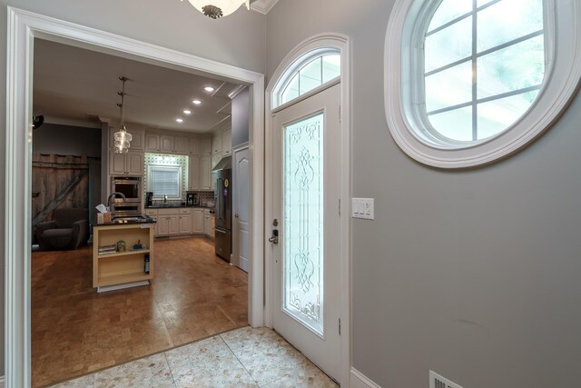 entryway featuring ornamental molding