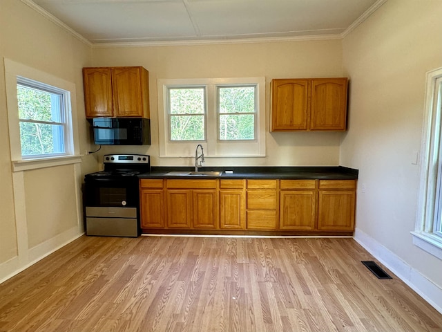 kitchen with stainless steel range with electric stovetop, sink, crown molding, and light wood-type flooring