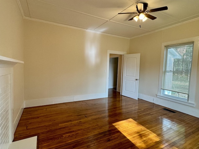 empty room featuring crown molding, ceiling fan, and dark hardwood / wood-style flooring