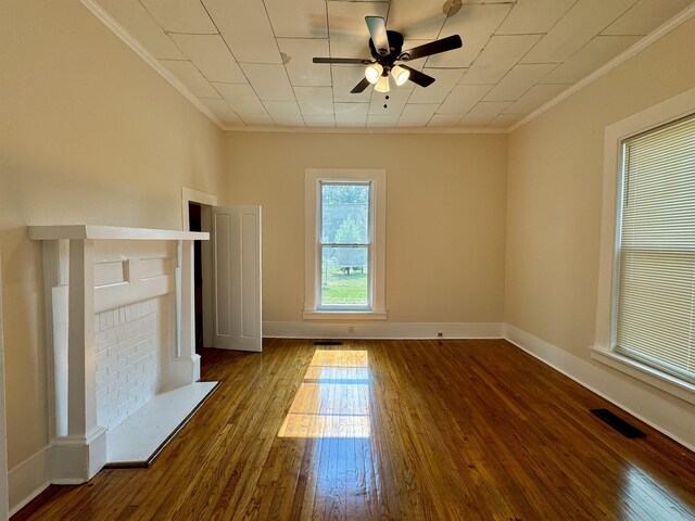 unfurnished living room with ornamental molding, ceiling fan, and dark hardwood / wood-style flooring