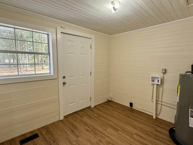 laundry area with water heater, hookup for a washing machine, hardwood / wood-style floors, and wooden ceiling