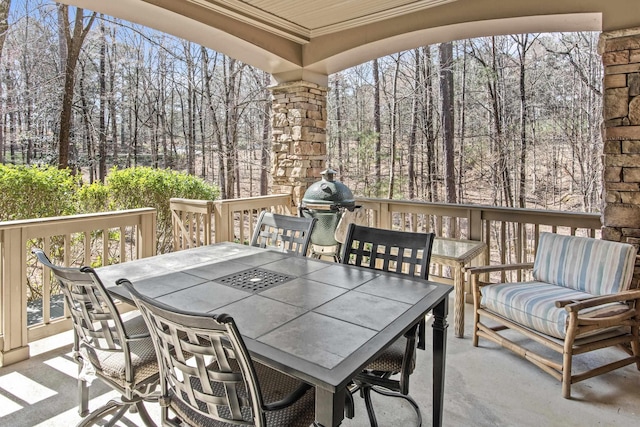 wooden terrace featuring outdoor dining area