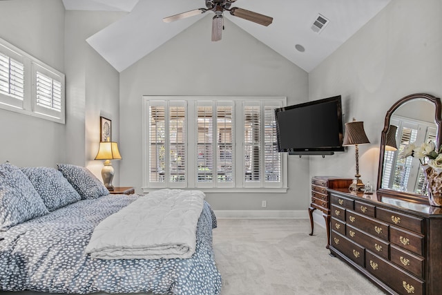 bedroom with lofted ceiling, light colored carpet, visible vents, and multiple windows