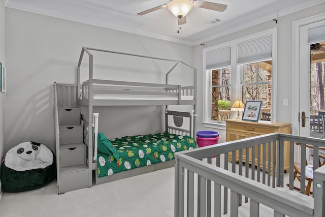 bedroom with ceiling fan, ornamental molding, carpet flooring, and visible vents