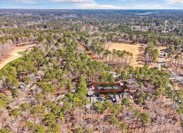 bird's eye view featuring a wooded view