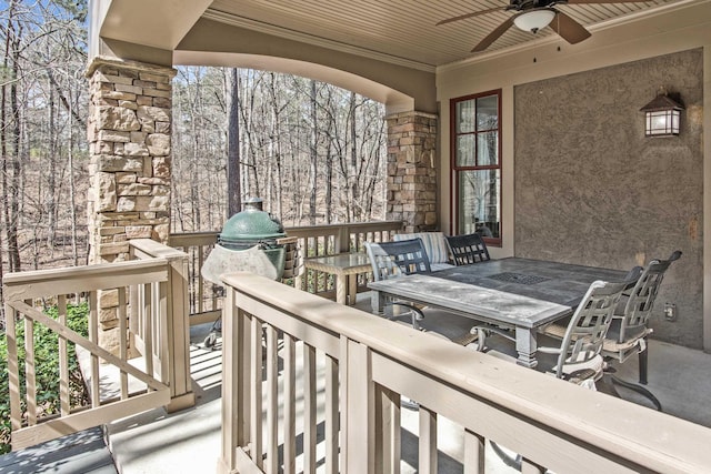 wooden terrace featuring ceiling fan and outdoor dining area