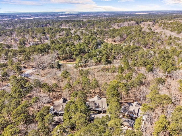 birds eye view of property with a view of trees