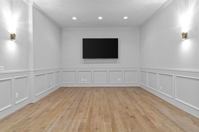 empty room with light wood-type flooring and ornamental molding