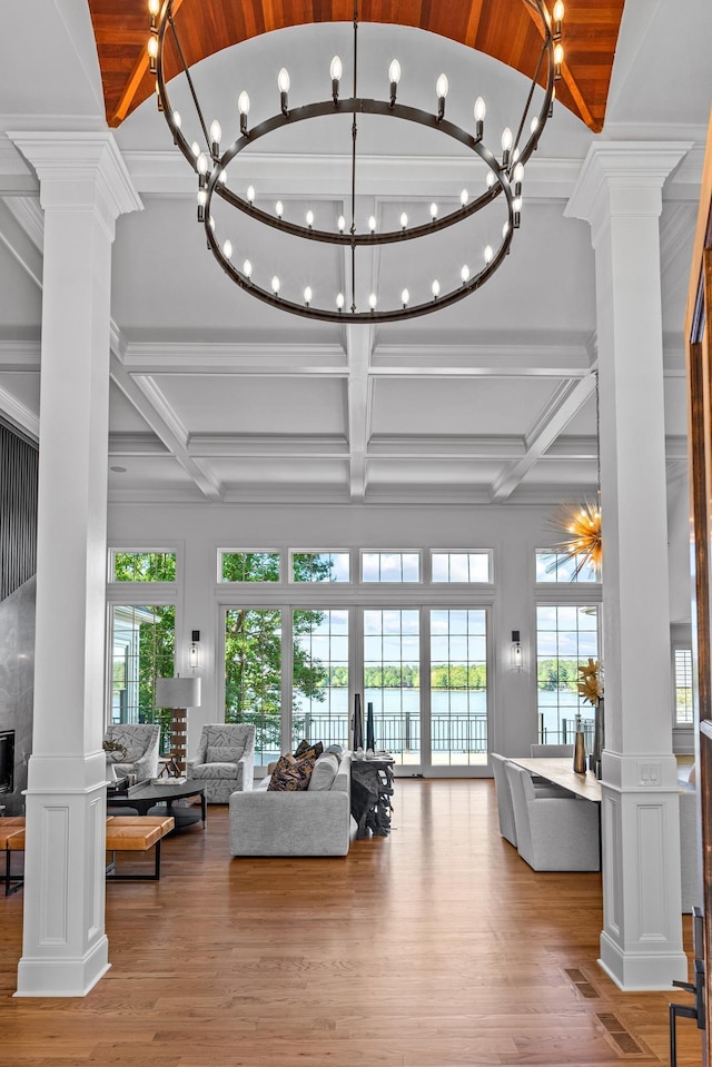 living room with coffered ceiling, hardwood / wood-style flooring, and decorative columns