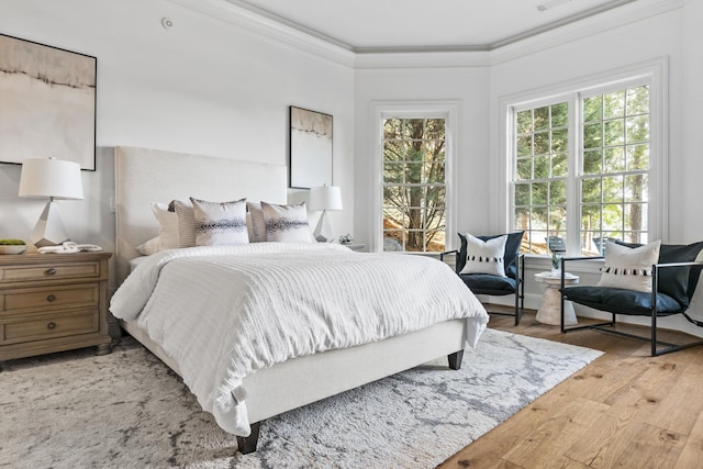 bedroom with crown molding and hardwood / wood-style floors