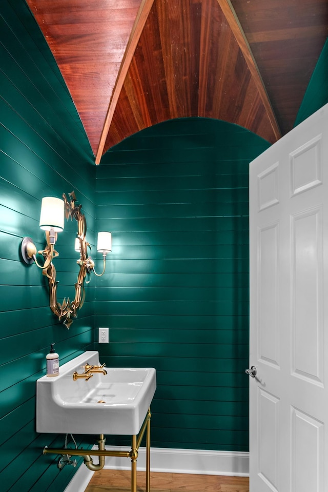 bathroom featuring sink, wood ceiling, and vaulted ceiling