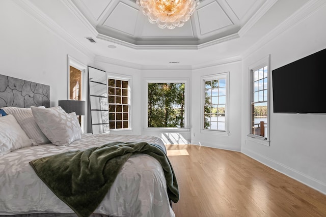 bedroom featuring coffered ceiling, ornamental molding, and wood-type flooring